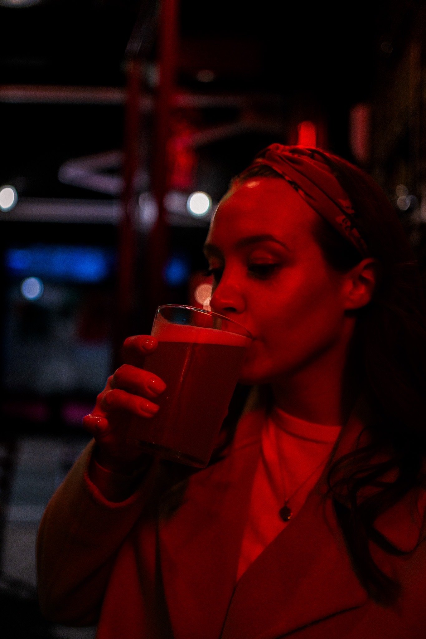 Woman drinking under red light
