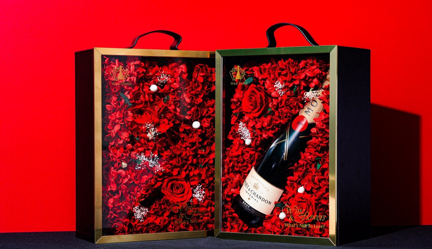 Wine bottle in a red flower gift box