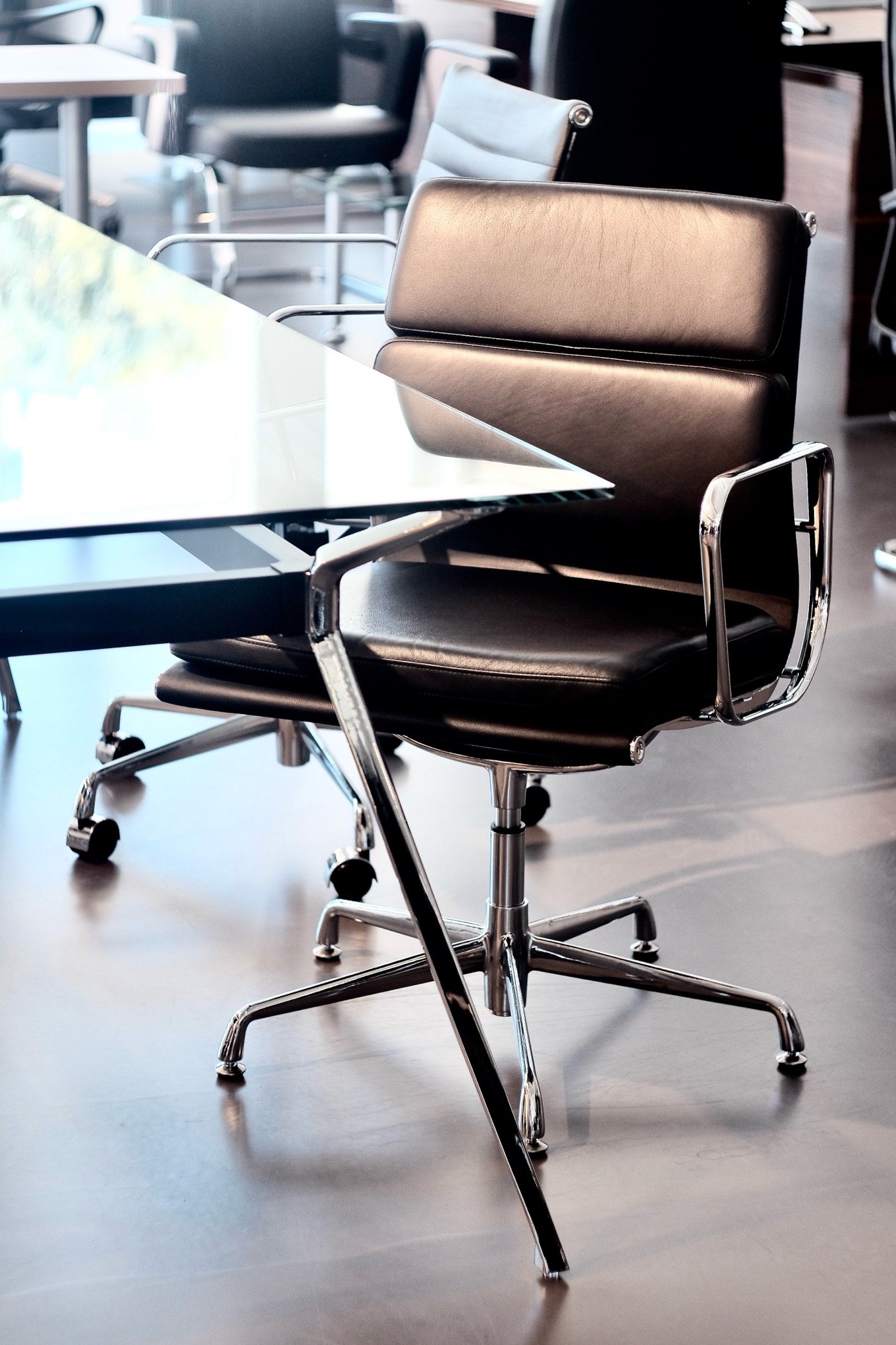 Leather office chair beside a glass desk, photographed for NORA Furnishings in Cyprus