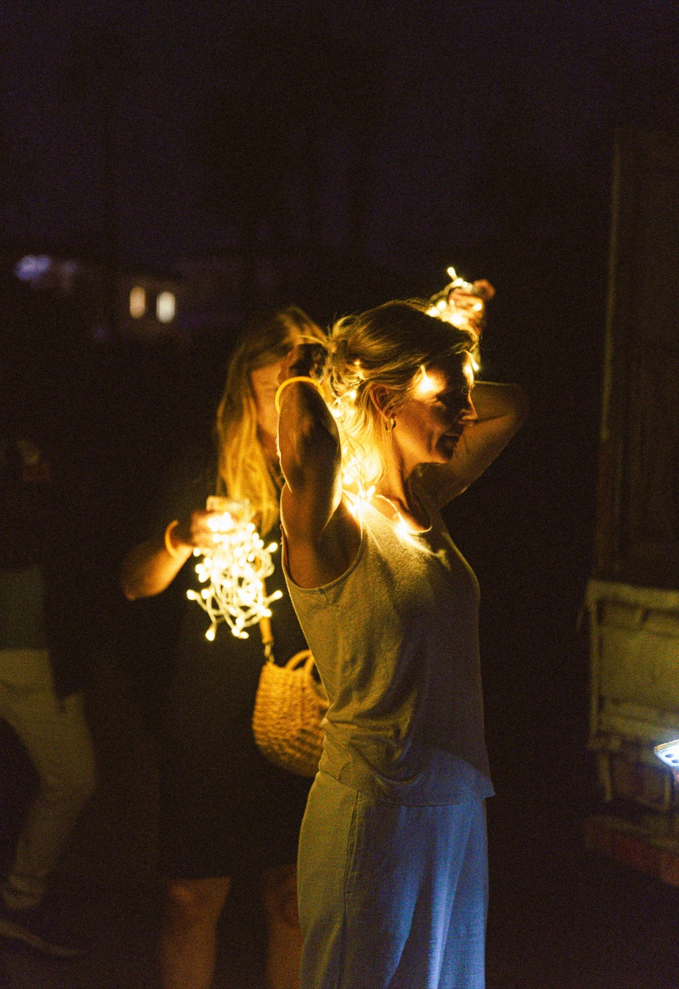 Woman holding a sparkler at night