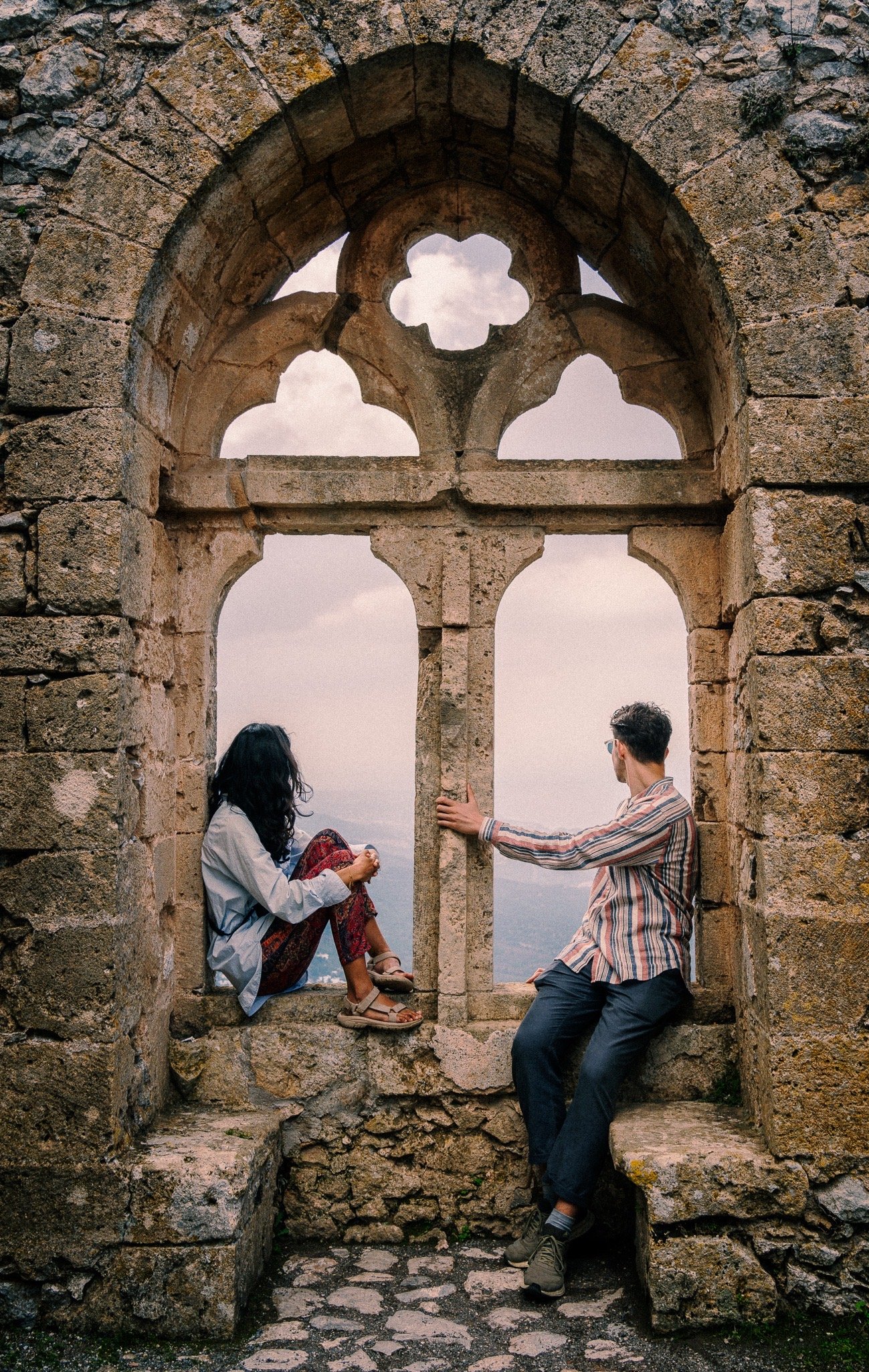 Couple framed by a stone window