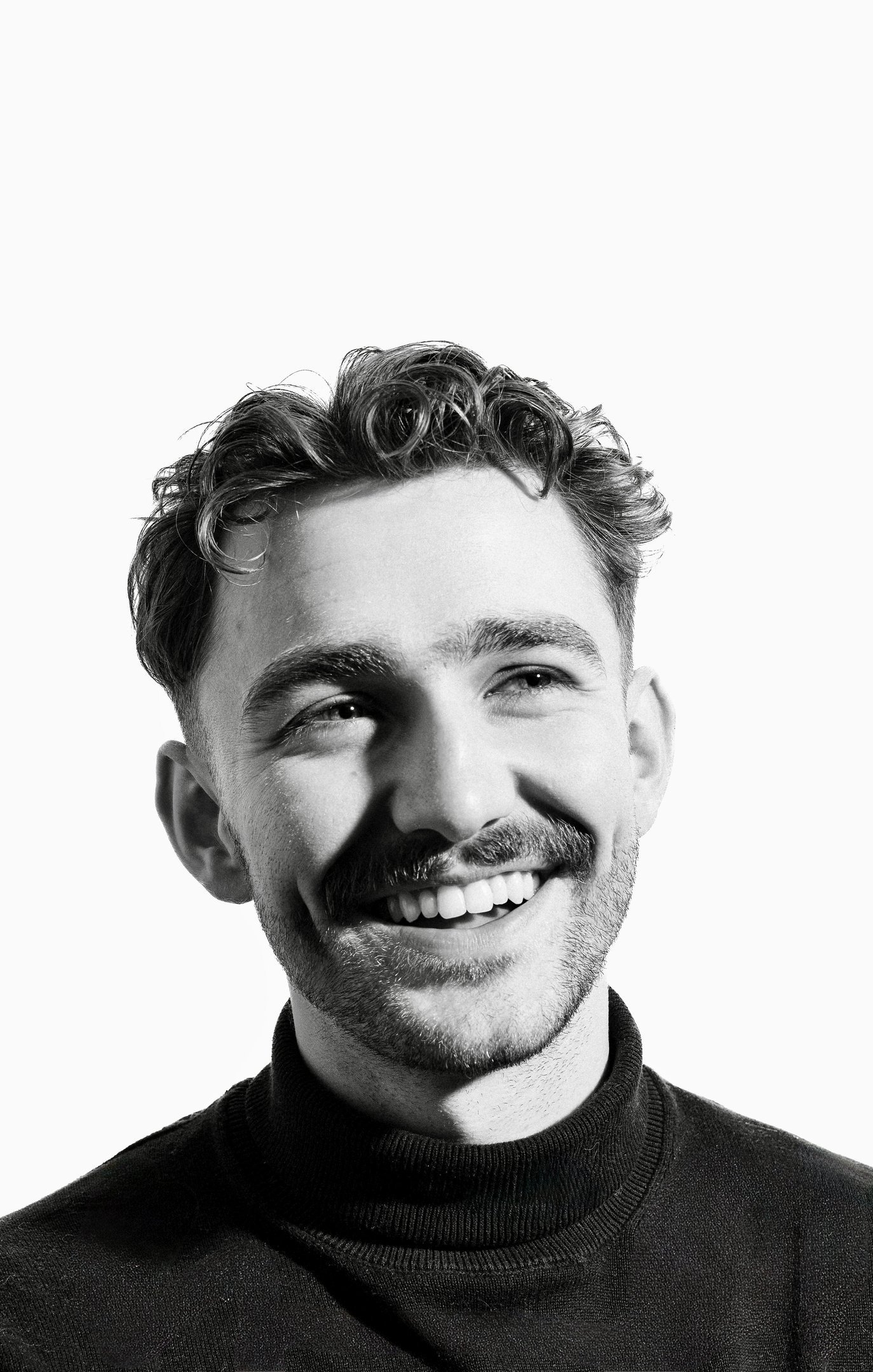 Black-and-white portrait of a smiling man