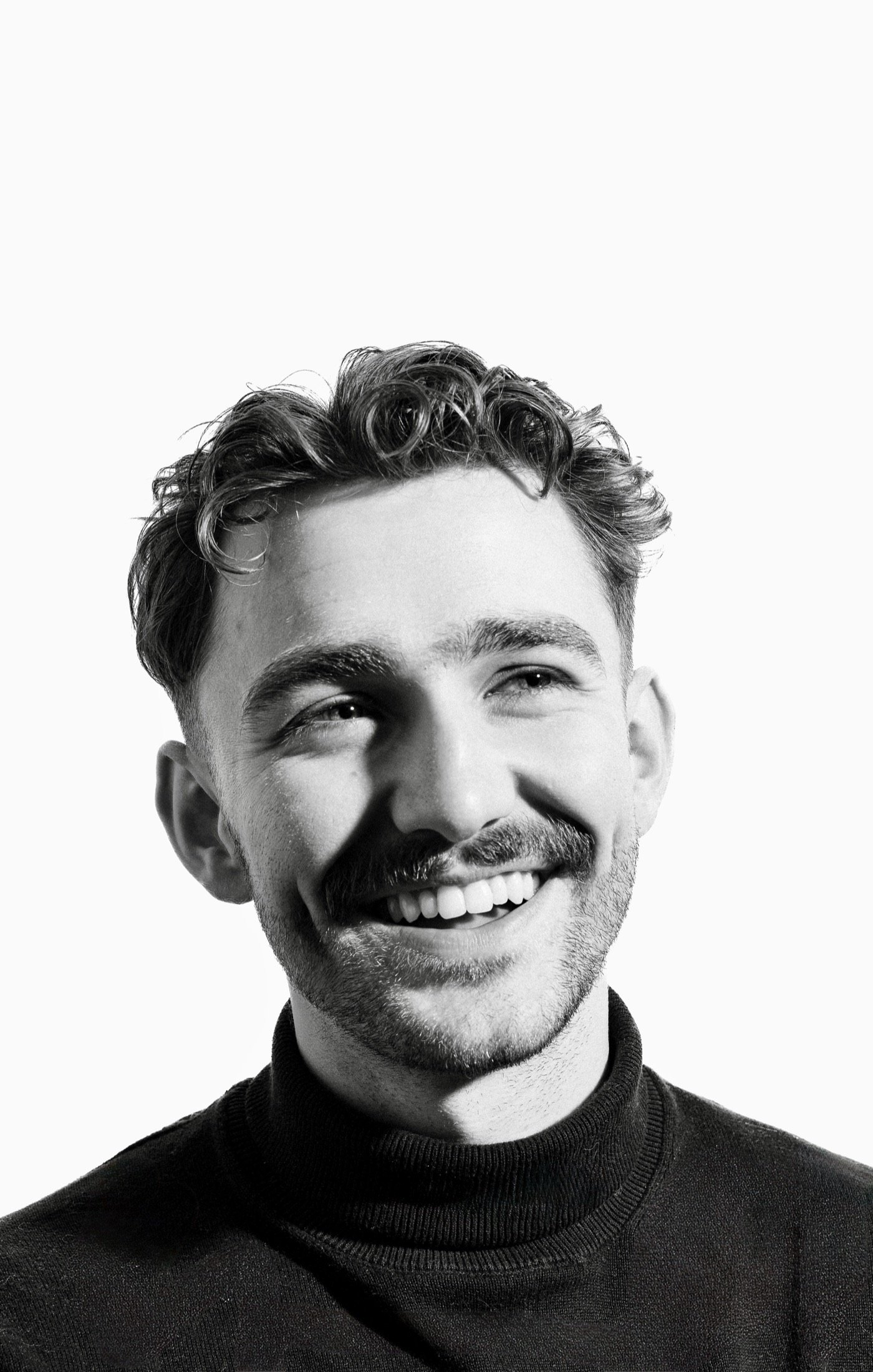 Black-and-white portrait of a smiling man