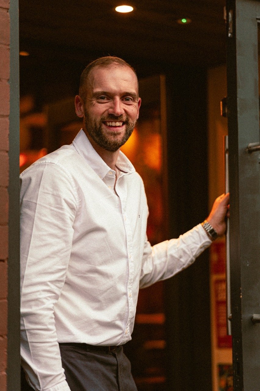 Smiling man in a warm interior