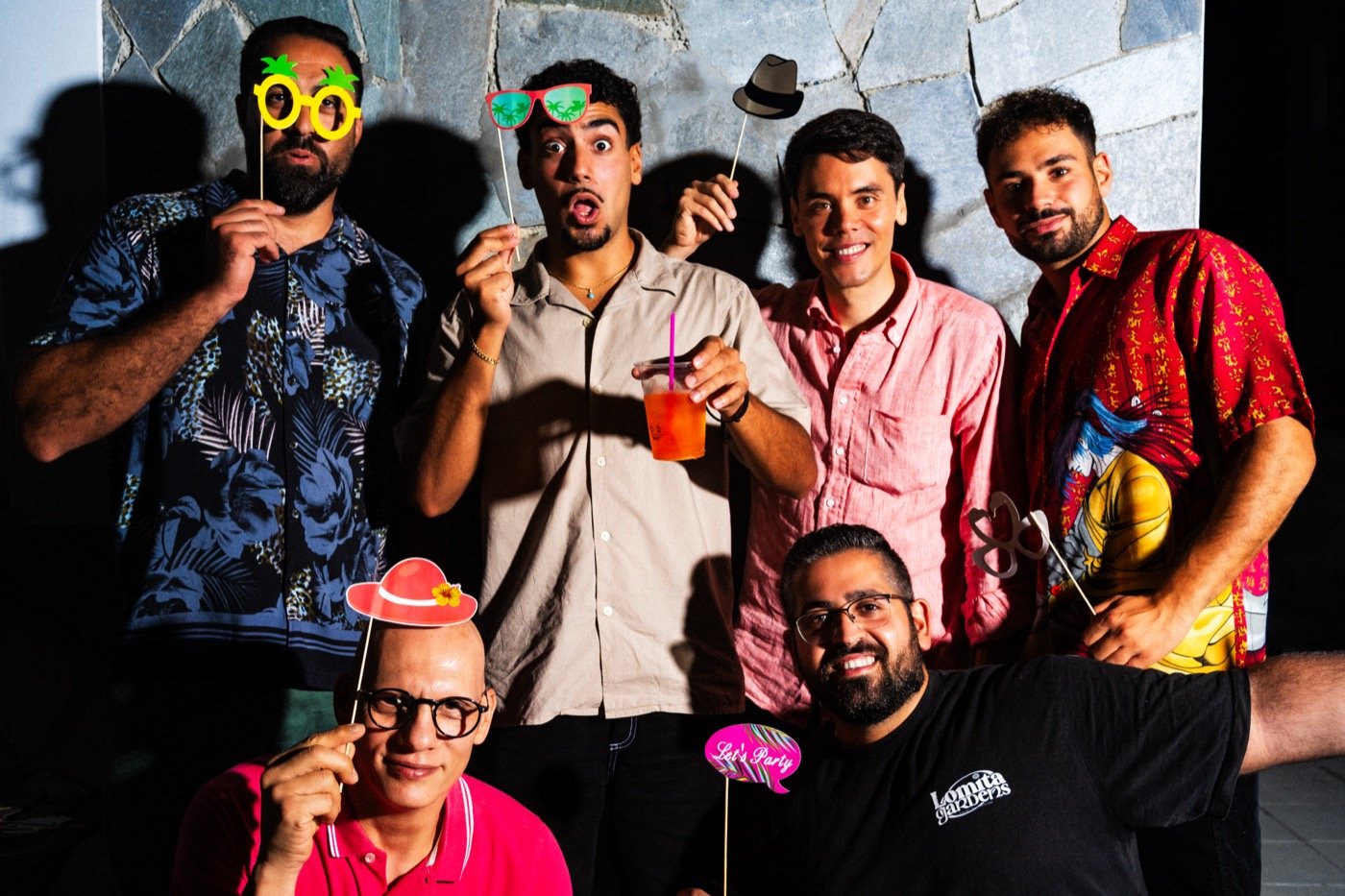 Group of friends posing with party props