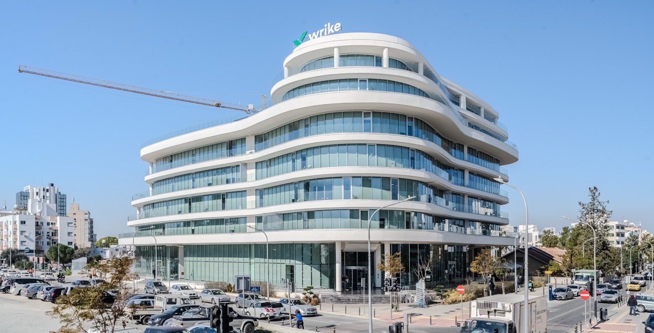 Curved white building against a blue sky