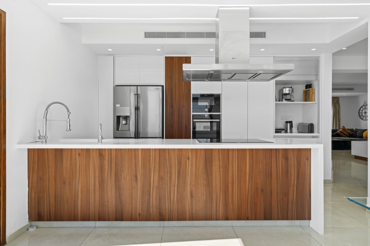 Modern kitchen with a walnut island and white cabinets
