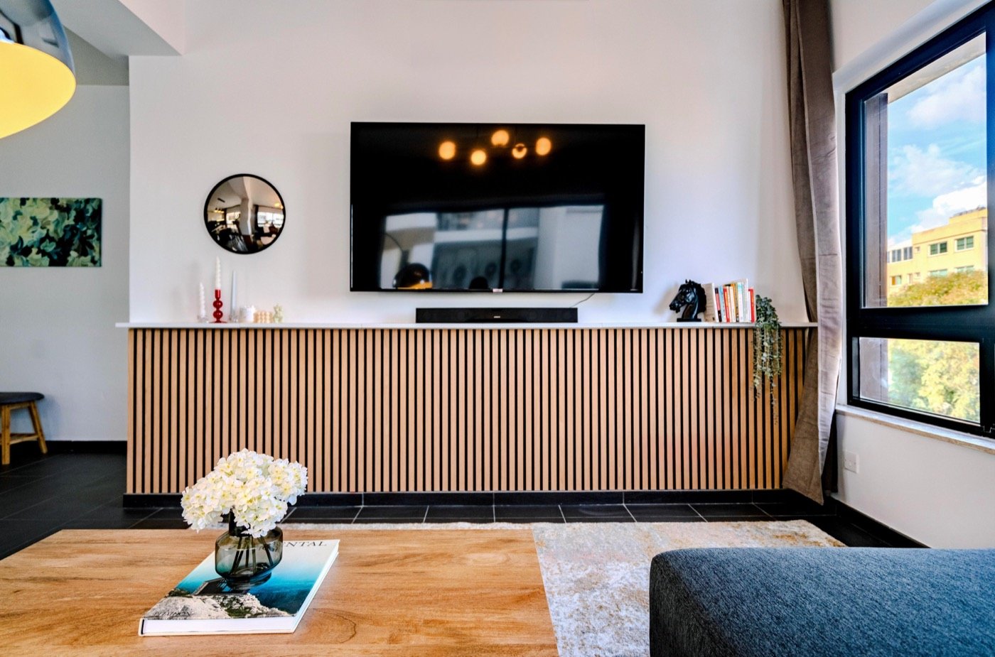 Open-plan living room with a wall-mounted TV