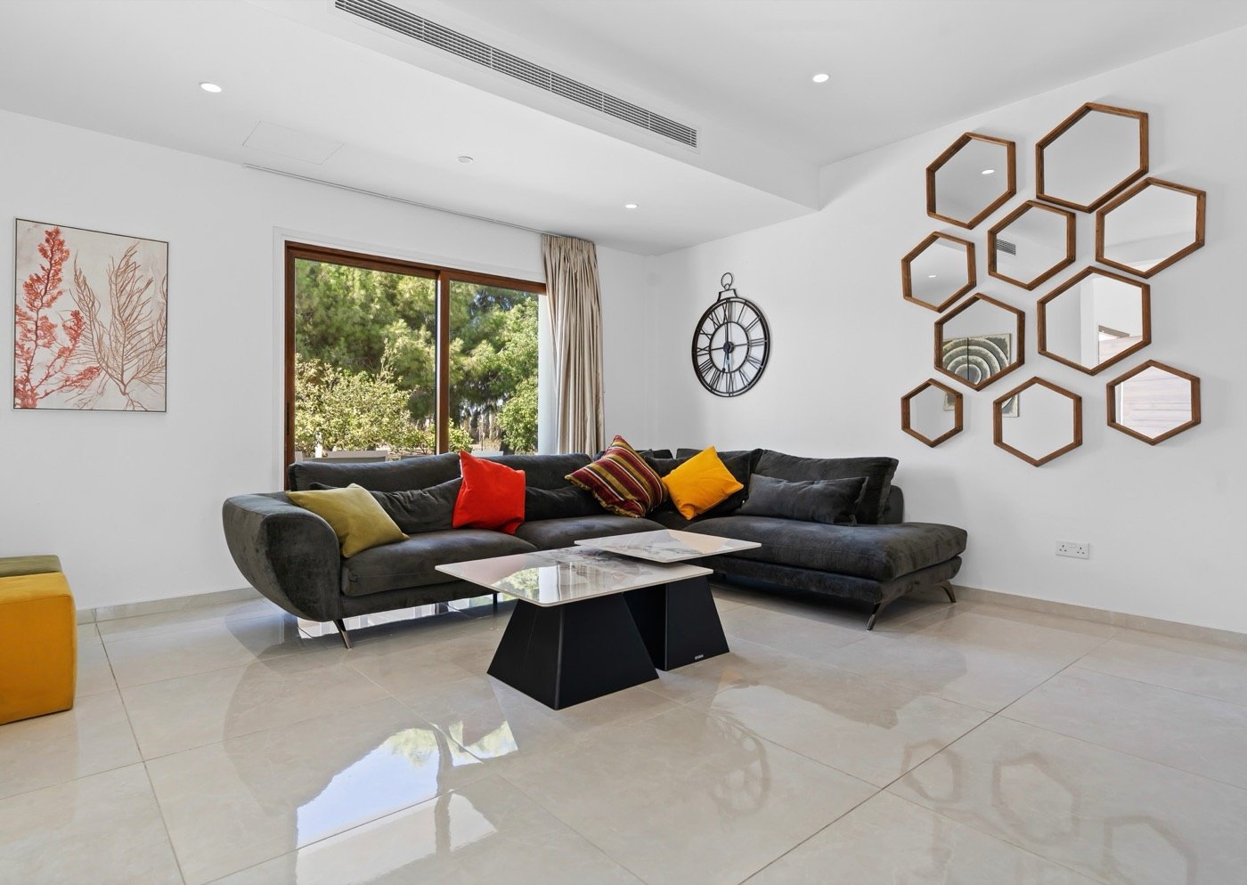 Living room with a corner sofa and hexagonal mirrors